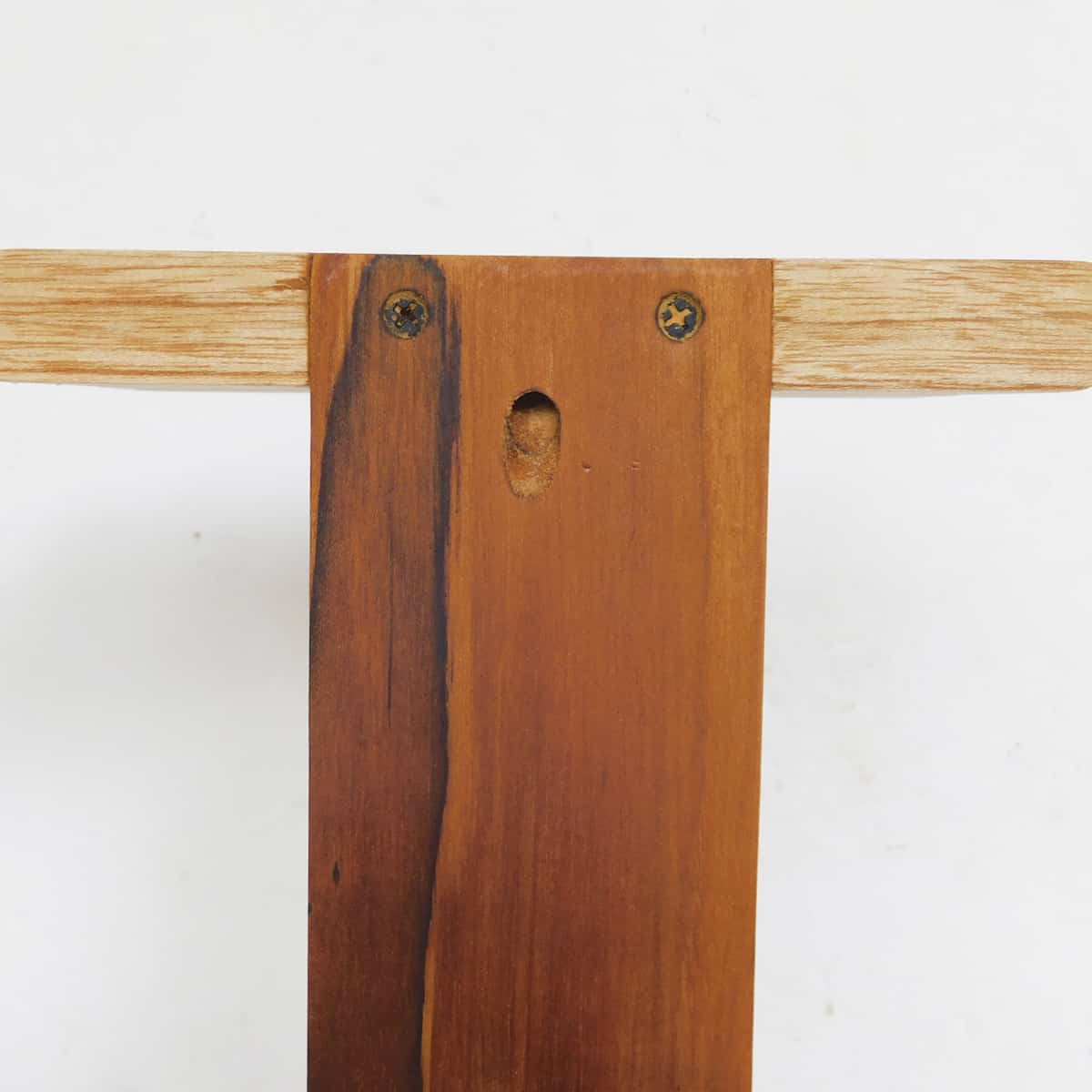 the back of a teak 4 tier wooden shelf