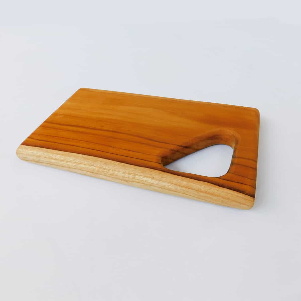 solid wood cutting board from a side view on a white background