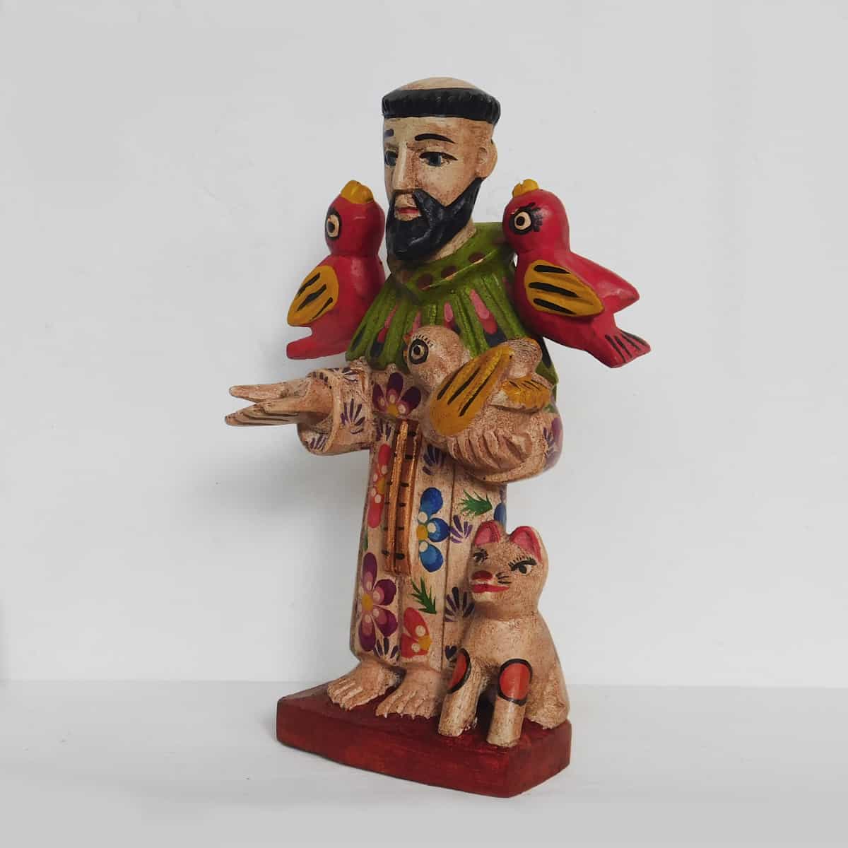 8 inch tall st francis of assisi figurine hand carved out of pine wood in guatemala on a white background