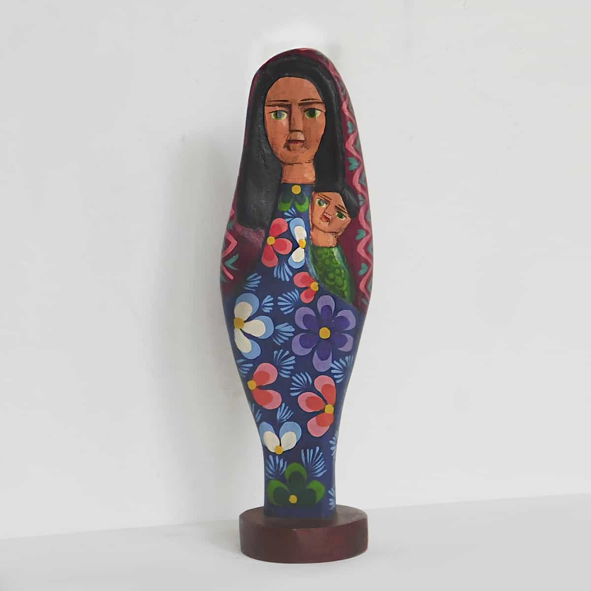 Virgin Mary Figurine holding Baby Jesus against a white backdrop.