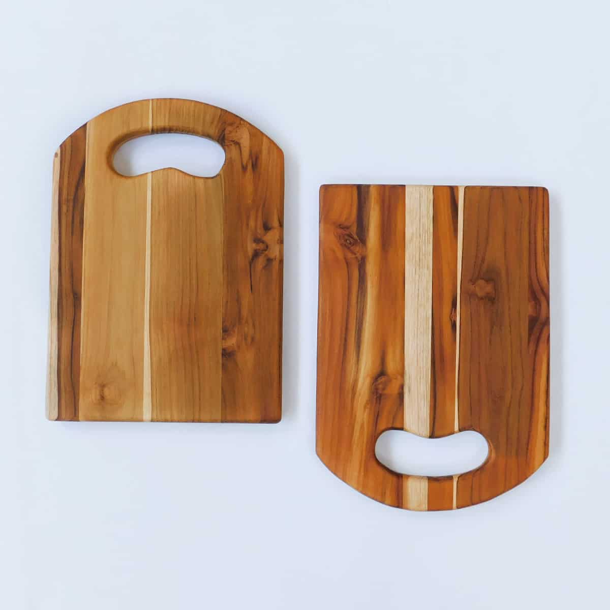 handmade wood cutting board set of 2 with rounded cutout handle on white background