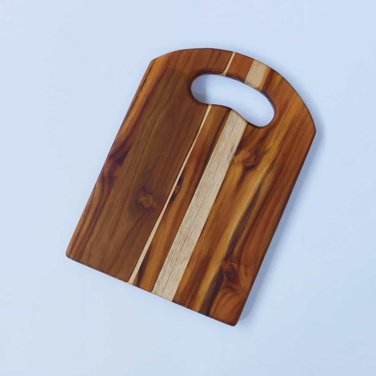 small teak cutting board with rounded top on white background