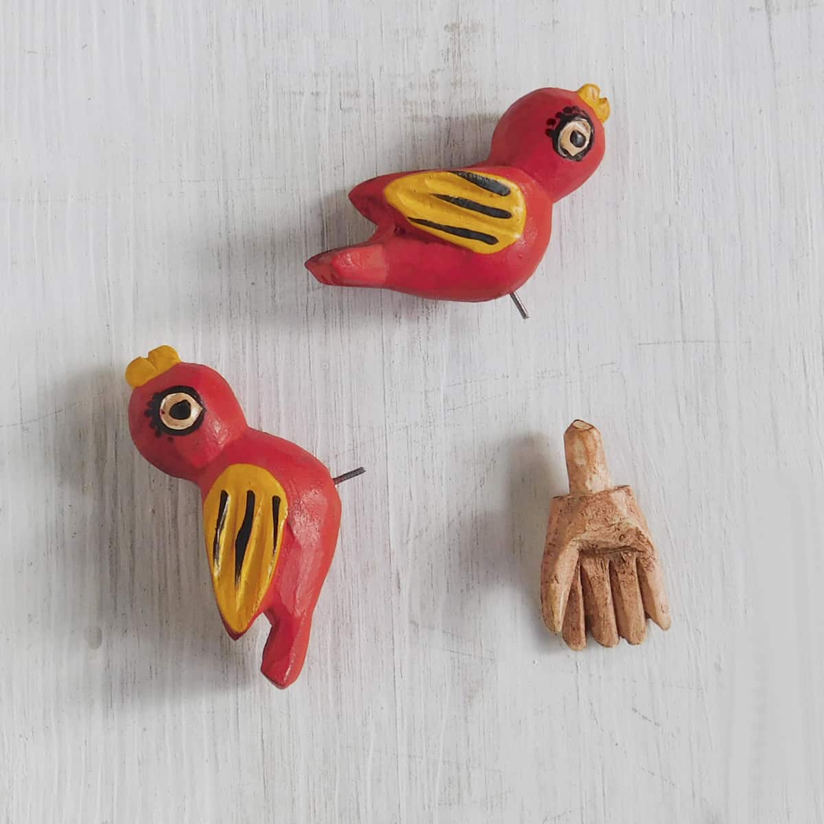 carved wooden figurines of removable birds and hand from a saint francis figurine
